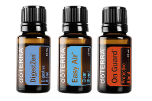 Three doterra essential oils labeled digestzen, easy air, and on guard, arranged in a row against a white background. Each bottle has a distinct colored label.