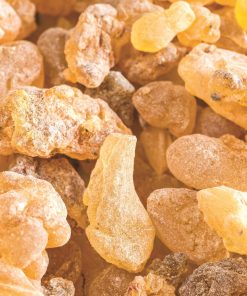 A close-up image of crystallized pieces of Natural Frankincense Essential Oil 100% Pure - 15ml, one of the best essential oils, displaying a range of amber colors and irregular shapes.