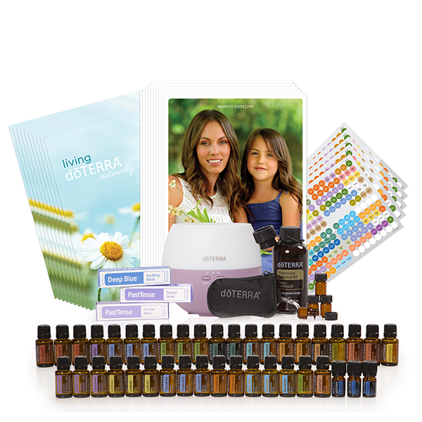 A promotional display of EarthSun Essentials products including a diffuser, multiple essential oil bottles such as rose oil arranged in rows, and printed materials like brochures and stickers.