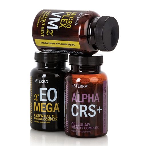 Three bottles of doTERRA supplements, named vEO Mega, xEO Mega, and Alpha CRS+, are displayed against a white background. The bottles are dark with colored labels indicating their contents as