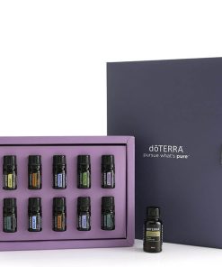 A Family Essentials Starter Pack Oil Kit - Pack Of 10 Bottles - 5ml Each displayed with an open purple and dark gray box containing ten assorted essential oil bottles, with one bottle placed in front of the box.