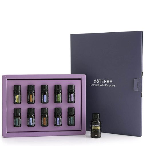 A Family Essentials Starter Pack Oil Kit - Pack Of 10 Bottles - 5ml Each displayed with an open purple and dark gray box containing ten assorted essential oil bottles, with one bottle placed in front of the box.