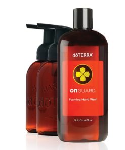 Three amber-colored plastic bottles of doTERRA On Guard foaming hand wash, infused with essential oil blends, with dispensers, arranged in a line on a white background. The front bottle is