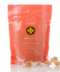 A package of On Guard® All Natural Softgel Beadlets, shown with a few lozenges outside the open bag. The package is coral with a white pattern and a green and