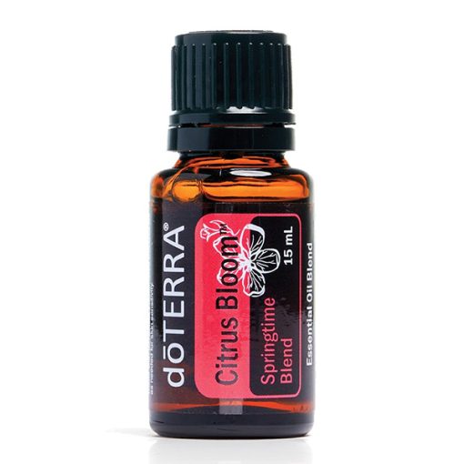A small, brown glass bottle of doterra citrus bloom essential oil blend, labeled with pink and black graphics displaying the product name and a floral design, isolated on a white background. This is one of