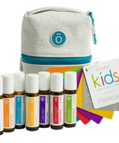 A collection of seven labeled essential oil blends for kids from doTERRA, alongside colorful flashcards, all displayed next to a white and teal bag with a paisley pattern.