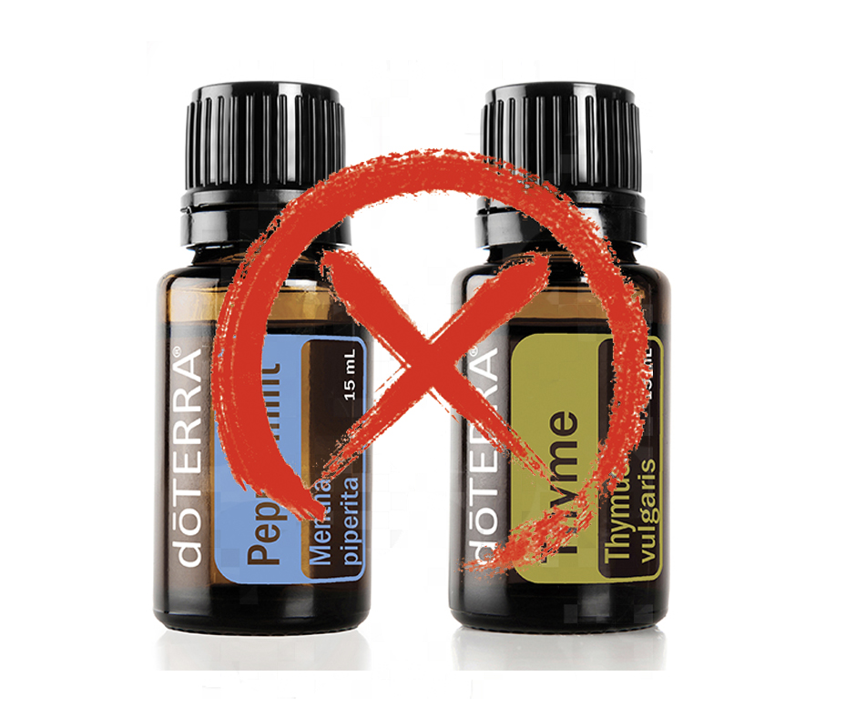 Two essential oil bottles labeled "peppermint" and "thyme" from doTERRA, with a red prohibition sign superimposed over them, against a white background.